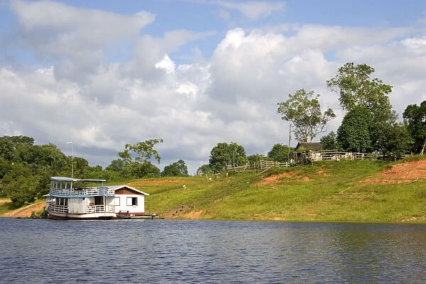 River boat and house on the Arasa River in the Amazon jungle near Manaus, Brazil