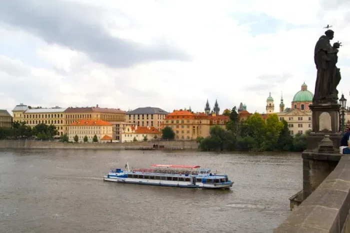 Framed Print : River boat on Vitava River and the famous Charles Bridge of tourist city of Prague Framed Print : River boat on Vitava River and the famous Charles Bridge of tourist city of Prague