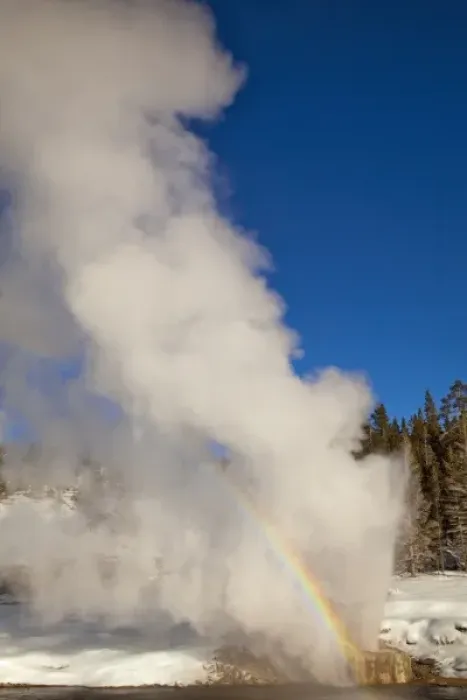Framed Print : Riverside Geyser erupts along the Firehole River on a nice sunny winter day in Yellowstone