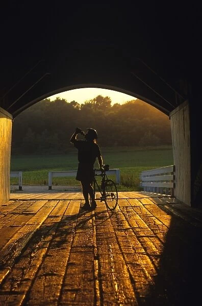 Road bicyclist takes water break at the Hogback Covered Bridge in Madison County