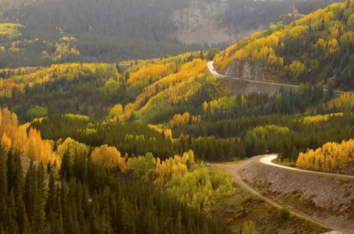 Framed Print : A road meanders through the brilliant fall colors of the San Juan Mountains of Colorado