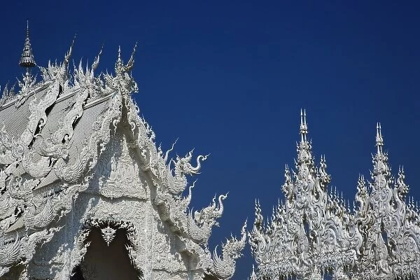 Rooftop architectural details of the new all white temple of What Rong Khun in Tambon