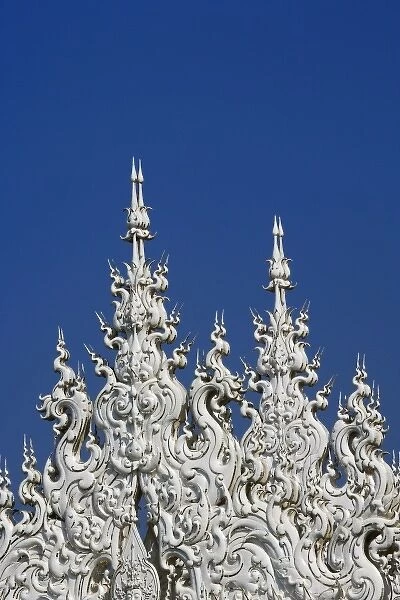 Rooftop architectural details of the new all white temple of Wat Rong Khun in Tambon