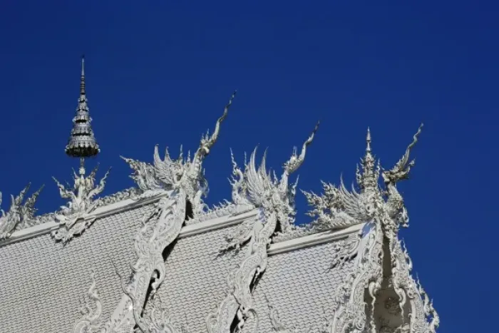 Framed Print : Rooftop architectural details of the new all white temple of Wat Rong Khun in Tambon Framed Print : Rooftop architectural details of the new all white temple of Wat Rong Khun in Tambon