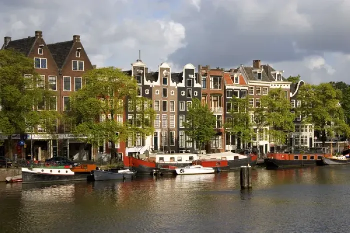 Framed Print : Row houses along the Amstel River in Amsterdam, Netherlands Framed Print : Row houses along the Amstel River in Amsterdam, Netherlands