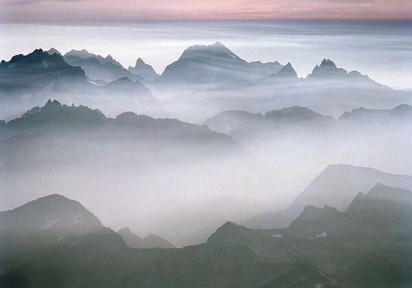 The rugged peaks of North Cascades National Park seen through mist with a band of