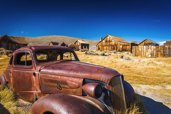 Rusted car and buildings, Bodie State Historic Park, California USA