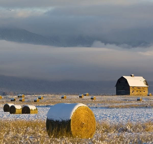Rustic barn and hay bales after a fresh snow in the Mission Valley of Montana