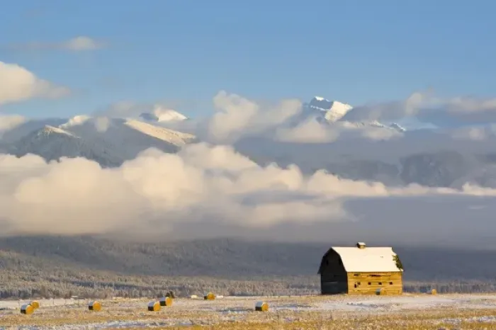 Framed Print : Rustic barn and hay bales after a fresh snow in the Mission Valley of Montana