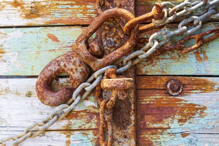 Framed Print : Rusty lock and chain on light blue wood