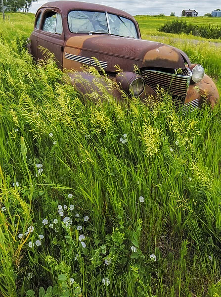Rusty old vehicles in the ghost town of Okaton, South Dakota, USA