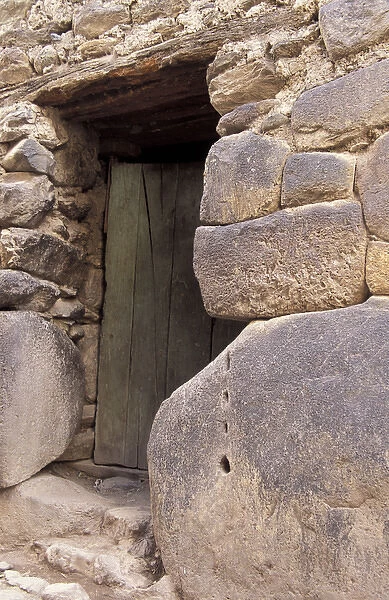 SA, Peru, Ollantaytambo Front entrance to home with large and small stones