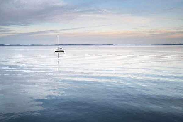 Sailboat anchored in Bellingham Bay on a calm morning, Bellingham, Washington State
