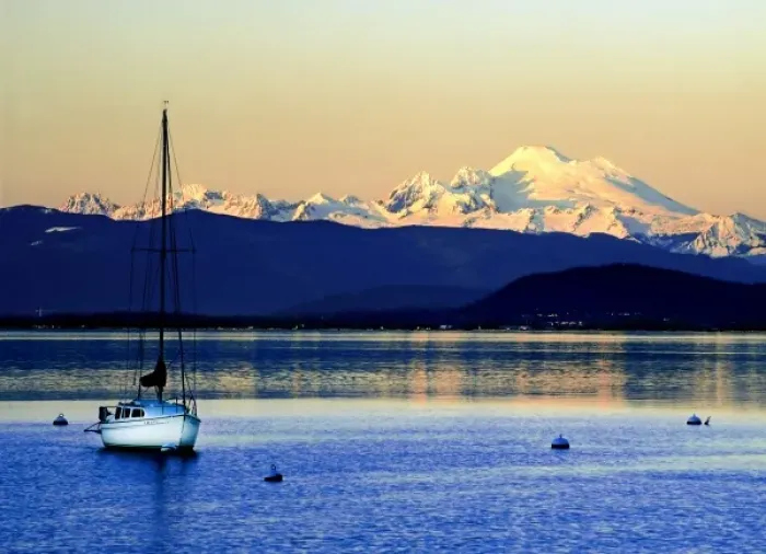 Framed Print : Sailboat anchored on Camano Island is swarfed by Mt. Baker