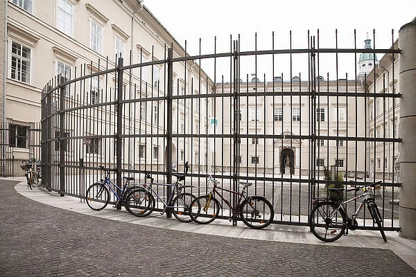 Salzburg, Salzburg, Austria - Bicycles parked against a tall, wrough-iron fence