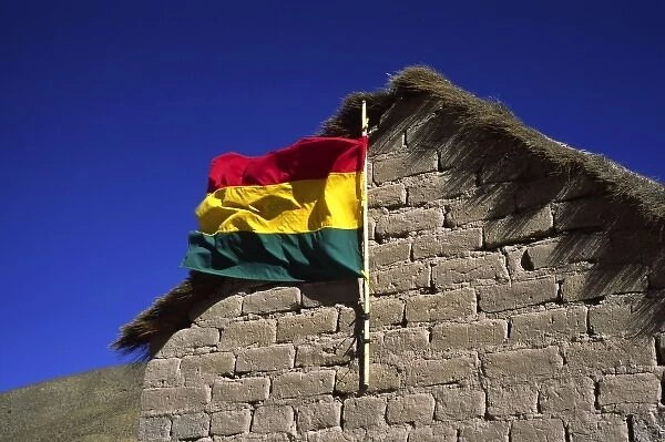 San Antonio, Bolivia, Bolivian flag waving from a mud brick hut in the High Altiplano
