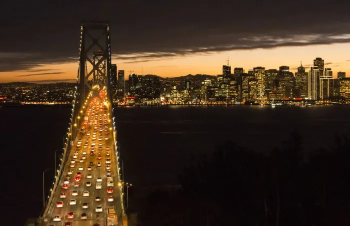 Framed Print : San Francisco California skyline and the Oakland Bay Bridge at evening with traffic on bridge