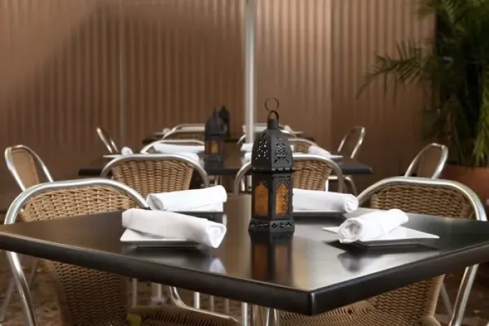 Framed Print : San Juan, Puerto Rico - A lamp is sitting on a restaurant table unlit. Surrounding