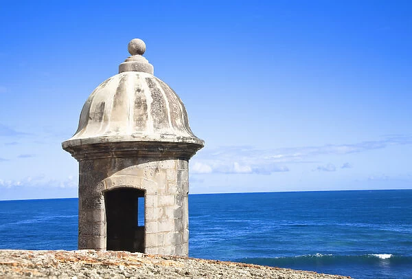 San Juan, Puerto Rico - An old stone watchtower looks out over the ocean. Horizontal shot