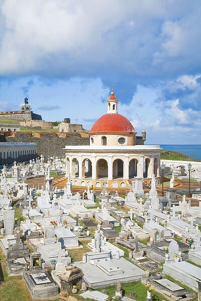 San Juan, Puerto Rico - An orange dome tops a building in a cemetery. In the background