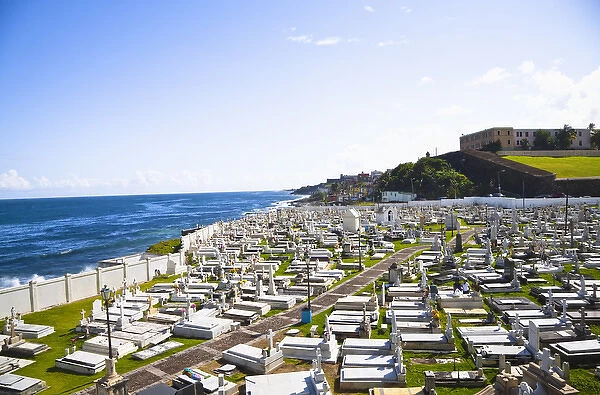 San Juan, Puerto Rico - Tombs and religious statuary mark graves in a cemetery near the ocean