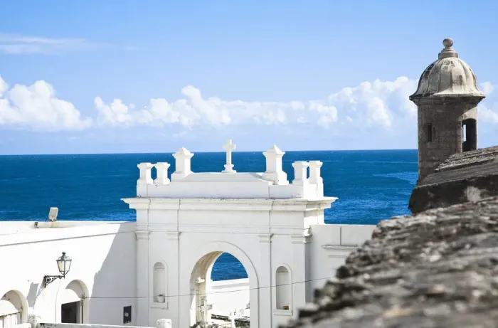 Framed Print : San Juan, Puerto Rico - A white building holds the entrance to a cemetery while above Framed Print : San Juan, Puerto Rico - A white building holds the entrance to a cemetery while above