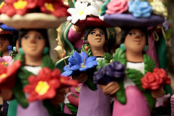 Santa Fe, New Mexico, United States. Clay Mexican women with flowers. Oxacan style