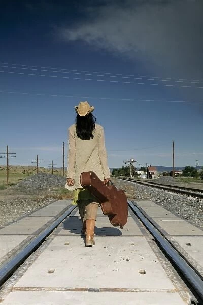 Santo Domingo Pueblo, New Mexico, United States. Native woman head down the tracks. (MR)