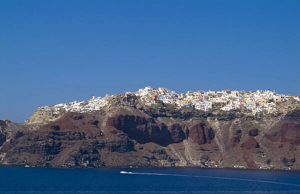 Santorini Greece and the beautiful white buildings on the mountain cliffs from a ship