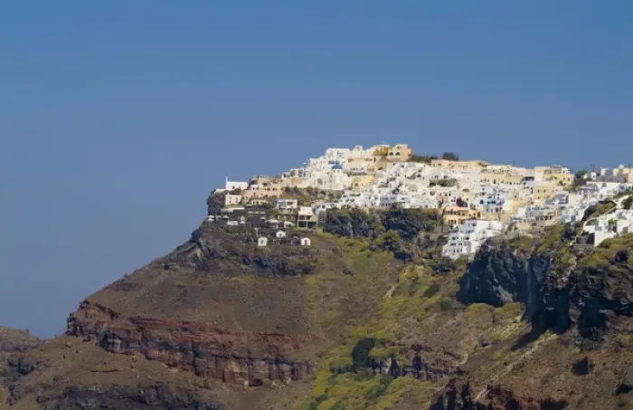 Framed Print : Santorini Greece and the beautiful white buildings on the mountain cliffs of main