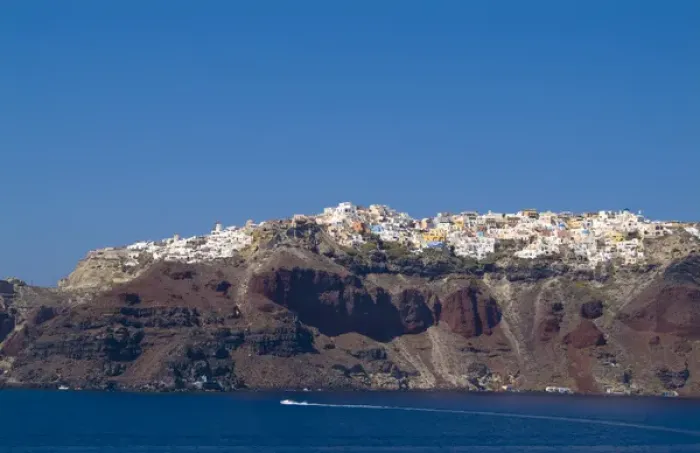 Framed Print : Santorini Greece and the beautiful white buildings on the mountain cliffs from a ship
