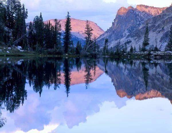 Sawtooth Wilderness, Idaho. USA. Cumulus clouds & Mount Everly reflected in unnamed lake at sunset