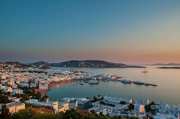 A scenic view of Chora and the nearby sea at sunset. Chora, Mykonos Island, Cyclades Islands, Greece