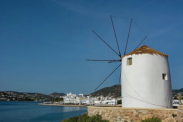 A scenic view of the Parikia waterfront and a traditional windmill. Parikia, Paros Island, Cyclades Islands, Greece