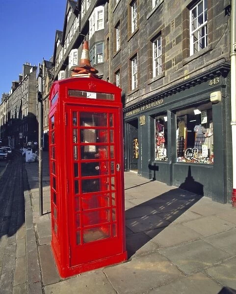 Scotland, East Lothian, Edinburgh. A bright red telephone booth stands out on a road in Edinburgh