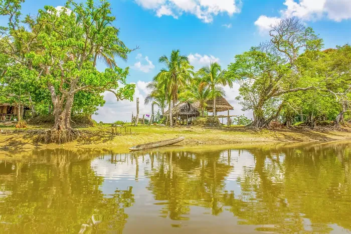 Framed Print : Sepik River, Papua New Guinea. Landscape view of a homestead and sandy banks reflected along the river
