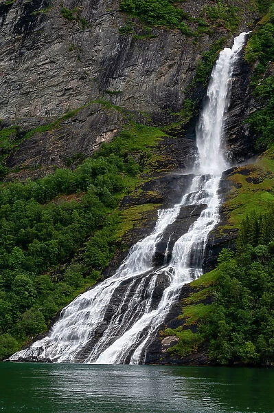 Seven Sisters waterfalls cascades off sheer cliffs into Geirangerfjord, Norway