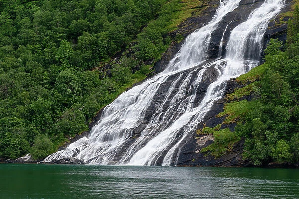 Seven Sisters waterfalls plunges off sheer cliffs into Geirangerfjord, Norway