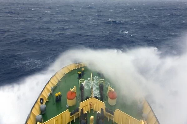 Ship navigating in the ocean through rough water, Antarctica