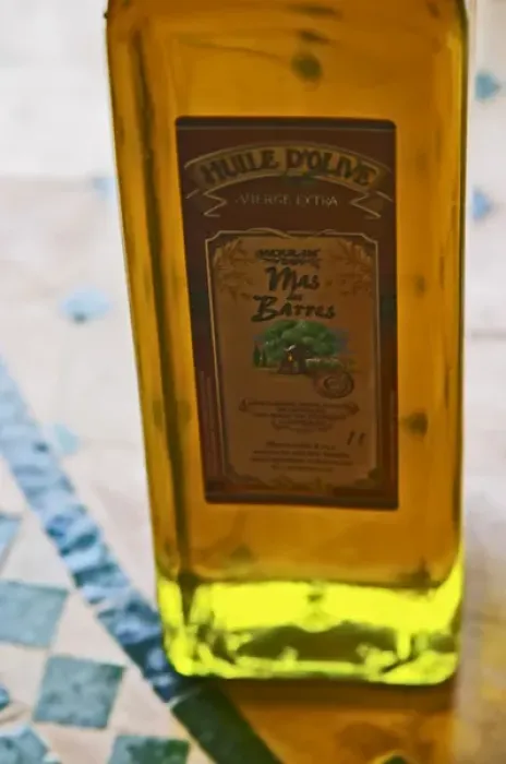 Framed Print : In the shop, a bottle of olive oil, back lit. Moulin Mas des Barres olive mill