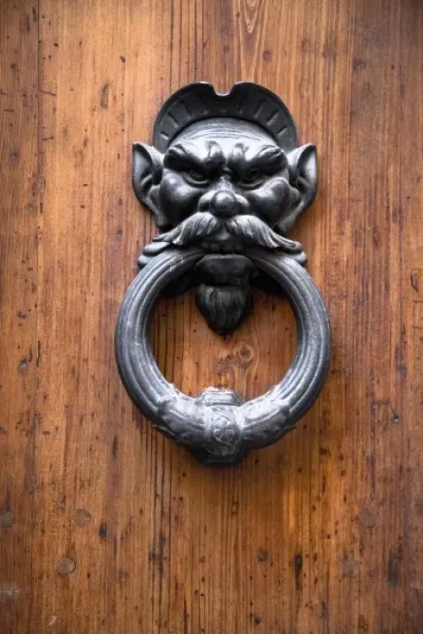 Framed Print : Sienna, Tuscany, Italy - Closeup of a metal door knocker in the shape of a mans face Framed Print : Sienna, Tuscany, Italy - Closeup of a metal door knocker in the shape of a mans face