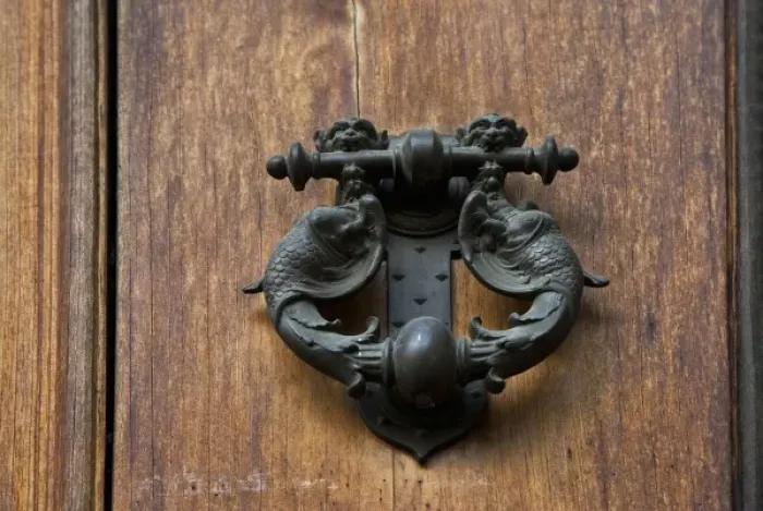 Framed Print : Sienna, Tuscany, Italy - Closeup of ornate, metal door knocker on a wooden door Framed Print : Sienna, Tuscany, Italy - Closeup of ornate, metal door knocker on a wooden door