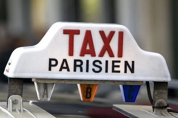 Sign atop a taxicab in Paris, France