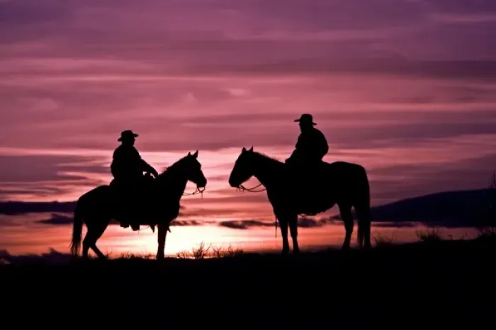 Framed Print : A silhouette of two cowboys on horses with the winter sky on The Hideout Ranch in Shell Wyoming Framed Print : A silhouette of two cowboys on horses with the winter sky on The Hideout Ranch in Shell Wyoming