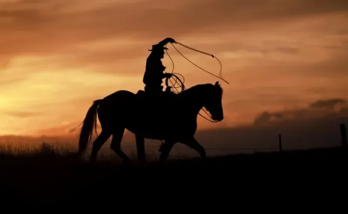 Framed Print : A silhouetted cowboy riding alone a ridge at sunset in Shell Wyoming Framed Print : A silhouetted cowboy riding alone a ridge at sunset in Shell Wyoming
