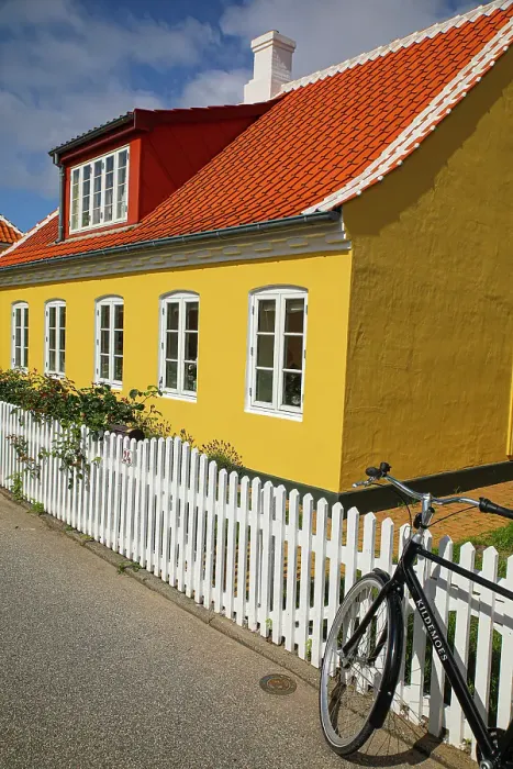 Framed Print : Skagen, Denmark. Bike, yellow house with white picket fence and terra cotta roof. (Editorial Use Only) Framed Print : Skagen, Denmark. Bike, yellow house with white picket fence and terra cotta roof. (Editorial Use Only)