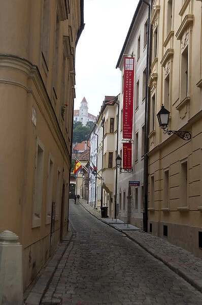 Slovakia, Bratislava. Narrow street in historic district with view of Bratislava