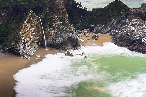 Slow moving waves into the cove of McWay Falls in Big Sur