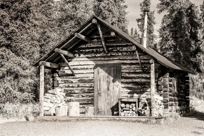 Framed Print : Small, rustic log home in sepia