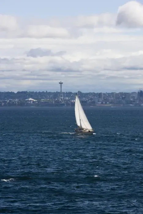 Framed Print : A small sailboat is propelled by a strong burst of wind off the coast of Seattle Framed Print : A small sailboat is propelled by a strong burst of wind off the coast of Seattle